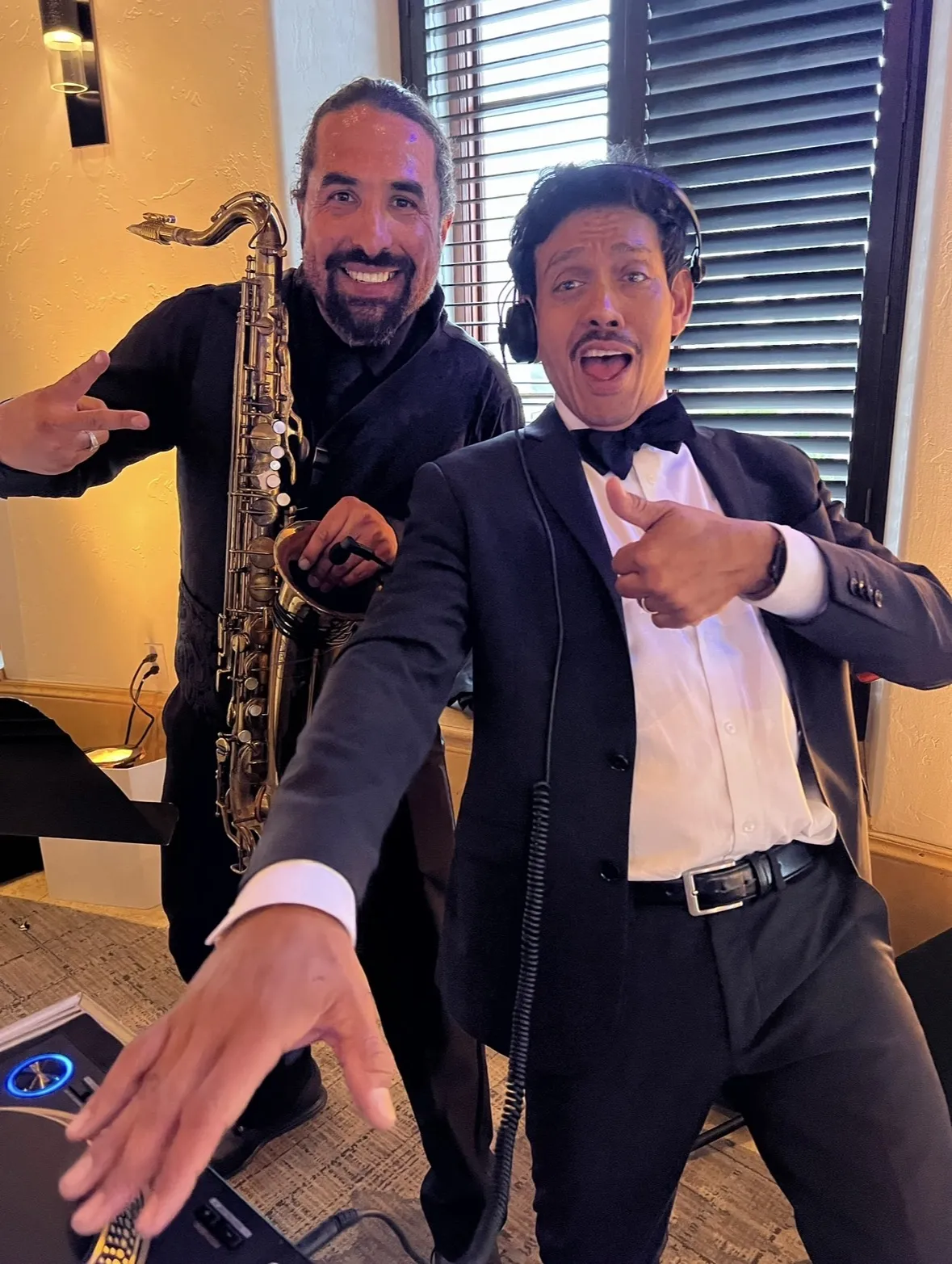 Live saxophonist playing alongside a wedding DJ on the dance floor