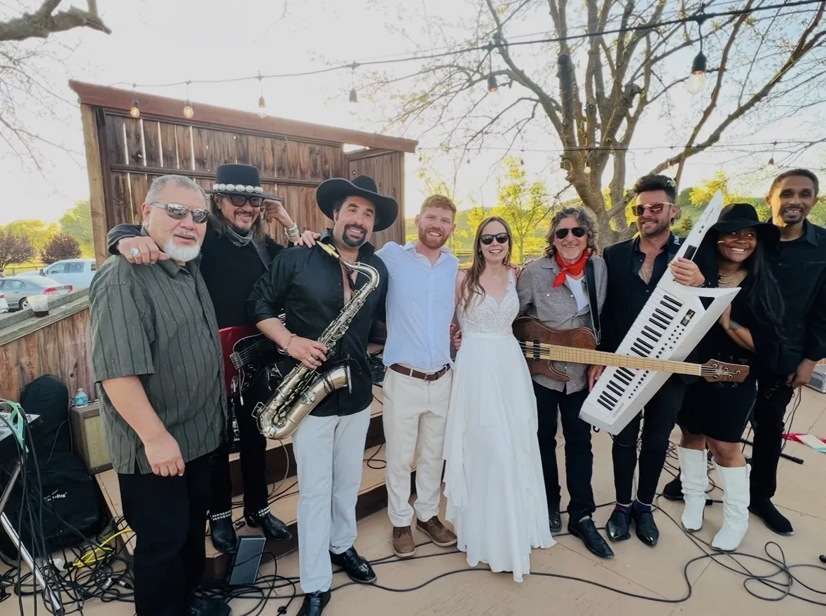 Live band members in action with vibrant stage lighting