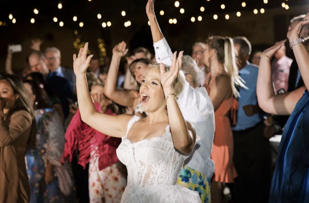 Packed dance floor with high energy lighting at a corporate event or wedding